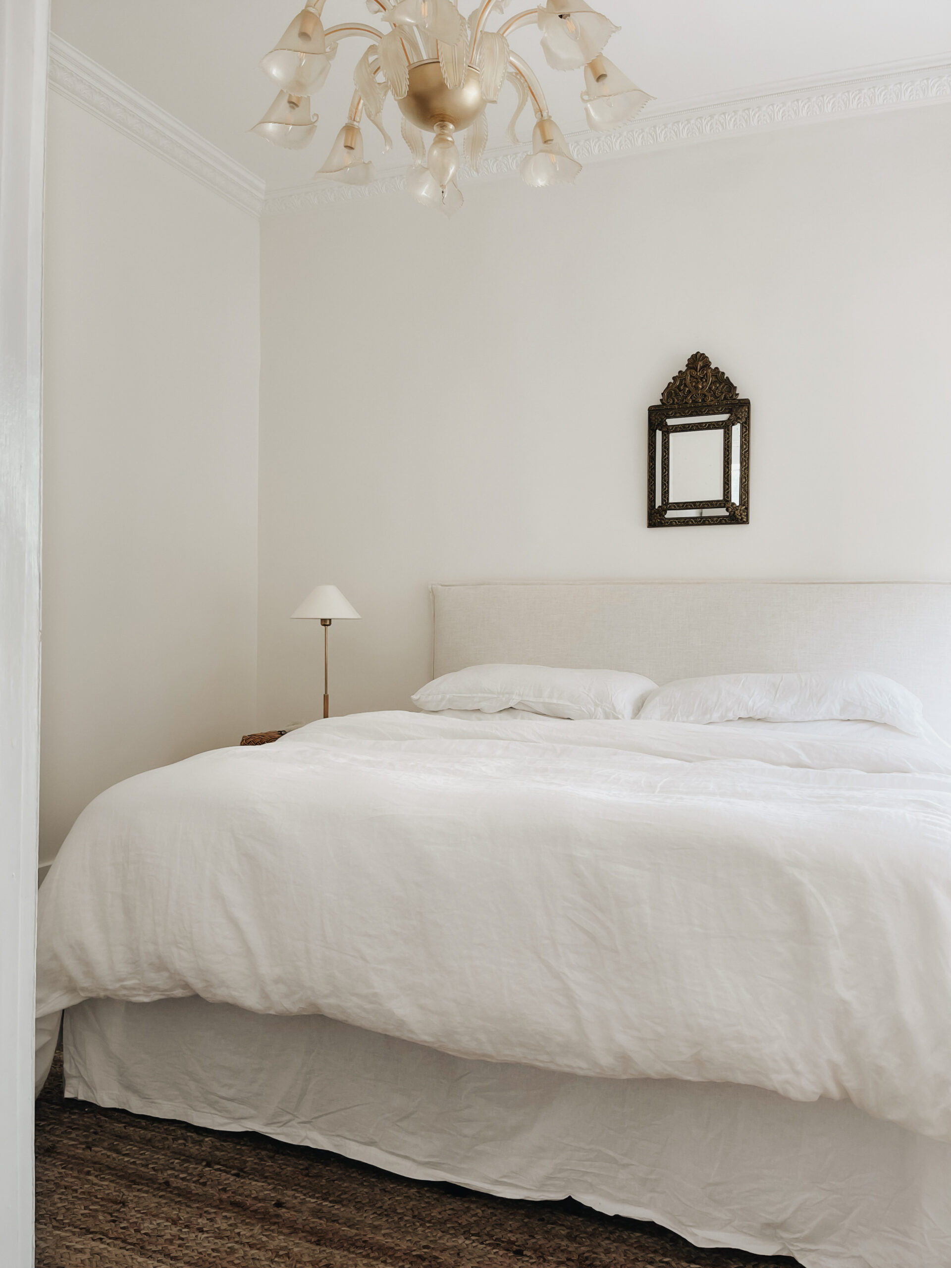 french beveled repousse mirror above bed